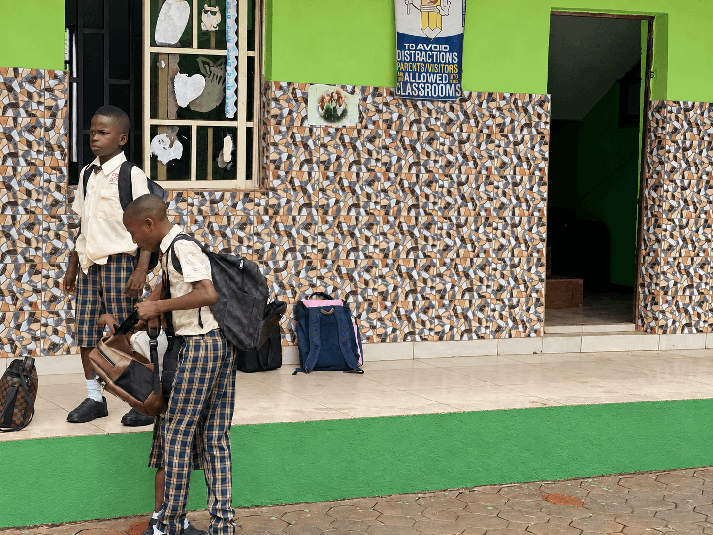 Tremad students outside a classroom block